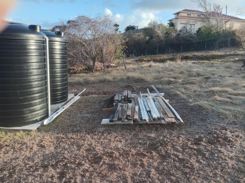 lumber and steel organized behind my water tanks